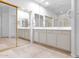 Bright bathroom featuring double sinks, tile flooring, large mirrors, and gold-framed shower at 15240 N Clubgate Dr # 168, Scottsdale, AZ 85254