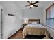 Cozy bedroom featuring a comfortable bed, wooden floors, and window with blinds at 15240 N Clubgate Dr # 168, Scottsdale, AZ 85254