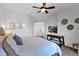 Cozy bedroom with a soft, patterned bedspread, ceiling fan, and a view into other rooms at 15240 N Clubgate Dr # 168, Scottsdale, AZ 85254