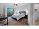 Bedroom with sliding door leading to a balcony, complemented by a ceiling fan at 15240 N Clubgate Dr # 168, Scottsdale, AZ 85254