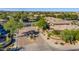 Lush landscaping and stone architecture define the gated community entrance with mature trees and flowering shrubs at 15240 N Clubgate Dr # 168, Scottsdale, AZ 85254