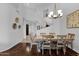 An elegant dining room features hardwood floors, a wooden table with seating for six, and a stylish light fixture at 15240 N Clubgate Dr # 168, Scottsdale, AZ 85254