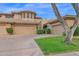Charming home with a tan exterior, two-car garage, and well-maintained landscaping at 15240 N Clubgate Dr # 168, Scottsdale, AZ 85254