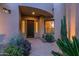 Inviting front porch at twilight with decorative plants and stylish front door at 15240 N Clubgate Dr # 168, Scottsdale, AZ 85254