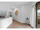 Bright hallway leading to the balcony with neutral decor, carpeted flooring, and shuttered door at 15240 N Clubgate Dr # 168, Scottsdale, AZ 85254