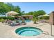 Community hot tub and pool area featuring a cabana, lounge chairs and mature shade trees at 15240 N Clubgate Dr # 168, Scottsdale, AZ 85254