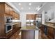 Modern kitchen featuring granite countertops, stainless steel appliances, with a large island and wine cooler at 15240 N Clubgate Dr # 168, Scottsdale, AZ 85254