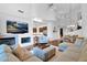 Open-concept living room with a cozy fireplace, large sectional, and seamless flow to the dining and kitchen areas at 15240 N Clubgate Dr # 168, Scottsdale, AZ 85254