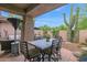 Inviting covered patio boasts a dining area and desert landscaping, perfect for enjoying outdoor meals at 15240 N Clubgate Dr # 168, Scottsdale, AZ 85254