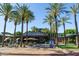 Open-air Shake Shack exterior view featuring outdoor seating and palm trees under a sunny sky at 15240 N Clubgate Dr # 168, Scottsdale, AZ 85254