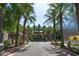 A long street view of storefronts, palm trees, mature trees, and sidewalks at 15240 N Clubgate Dr # 168, Scottsdale, AZ 85254