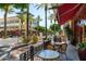 Street view of retail storefronts, lush landscaping and mature trees with outdoor seating at 15240 N Clubgate Dr # 168, Scottsdale, AZ 85254