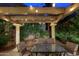 Inviting backyard patio with overhead lighting and lush landscaping for evening enjoyment at 15550 N Frank Lloyd Wright N Blvd # 1040, Scottsdale, AZ 85260