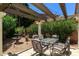 Relaxing backyard patio with a pergola, fountain, and lush landscaping at 15550 N Frank Lloyd Wright N Blvd # 1040, Scottsdale, AZ 85260