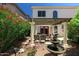 Private backyard patio with shaded pergola, a decorative fountain, and mature landscaping at 15550 N Frank Lloyd Wright N Blvd # 1040, Scottsdale, AZ 85260