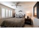 Cozy bedroom with a ceiling fan and plantation shutters for adjustable lighting at 15550 N Frank Lloyd Wright N Blvd # 1040, Scottsdale, AZ 85260