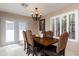 Inviting dining room with a classic chandelier, shuttered window, and seating for six at 15550 N Frank Lloyd Wright N Blvd # 1040, Scottsdale, AZ 85260