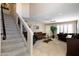 Bright living room with tile floors, ceiling fan, staircase, and comfortable sofas at 15550 N Frank Lloyd Wright N Blvd # 1040, Scottsdale, AZ 85260