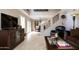 Spacious living area showcasing tile flooring, staircase, and ample natural light from French doors at 15550 N Frank Lloyd Wright N Blvd # 1040, Scottsdale, AZ 85260