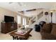 Cozy living room featuring comfortable seating, an entertainment center, and a staircase with ornate railing at 15550 N Frank Lloyd Wright N Blvd # 1040, Scottsdale, AZ 85260