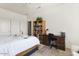 Bright bedroom with a bed, desk, and shelving unit with books and decor at 16974 W Marcos De Niza Dr, Surprise, AZ 85387