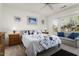 Bright bedroom with ceiling fan, large window, and carpet flooring at 16974 W Marcos De Niza Dr, Surprise, AZ 85387