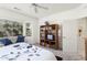 Bright bedroom with neutral walls, a bay window with sofa, and a bookcase with TV at 16974 W Marcos De Niza Dr, Surprise, AZ 85387