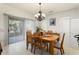 Bright dining room with chandelier, sliding glass doors to the yard, and tile flooring at 16974 W Marcos De Niza Dr, Surprise, AZ 85387