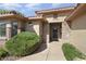 Inviting home entrance with stone accents, lush greenery, and a well-maintained walkway at 16974 W Marcos De Niza Dr, Surprise, AZ 85387