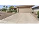 Home exterior featuring a neutral-toned garage door and desert landscaping at 16974 W Marcos De Niza Dr, Surprise, AZ 85387