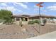 Well-maintained home featuring low-maintenance desert landscaping with cacti, gravel, and decorative rocks at 16974 W Marcos De Niza Dr, Surprise, AZ 85387