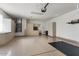 Clean and organized garage space with epoxy floors, storage cabinets, and utility connections at 16974 W Marcos De Niza Dr, Surprise, AZ 85387