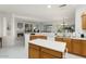 Spacious kitchen features breakfast bar, island, and an open floor plan to the living room at 16974 W Marcos De Niza Dr, Surprise, AZ 85387