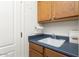 Functional laundry room featuring a sink, cabinets, and ample counter space at 16974 W Marcos De Niza Dr, Surprise, AZ 85387