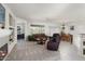 Spacious living room featuring a fireplace, comfortable seating, and an open layout into the dining area and kitchen at 16974 W Marcos De Niza Dr, Surprise, AZ 85387