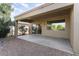 Covered patio with a view into the home's interior and desert landscaping at 16974 W Marcos De Niza Dr, Surprise, AZ 85387