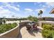 Cozy patio featuring a black metal table and chairs, perfect for enjoying the desert landscape and outdoor living at 16974 W Marcos De Niza Dr, Surprise, AZ 85387