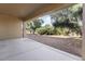 Covered patio offers an outdoor retreat with views of the landscaped backyard at 16974 W Marcos De Niza Dr, Surprise, AZ 85387
