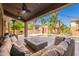 Beautiful backyard with a cozy seating area, lush landscaping, a pool, and a tranquil waterfall feature at 1808 S Sailors Way, Gilbert, AZ 85295