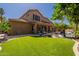 Lush backyard featuring a covered patio, a manicured lawn and outdoor seating at 1808 S Sailors Way, Gilbert, AZ 85295