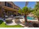 Charming outdoor living space with comfortable seating, a pool and well-manicured landscaping at 1808 S Sailors Way, Gilbert, AZ 85295