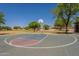 Well-maintained community basketball court featuring hoops, court markings, and greenery, ideal for outdoor recreation at 1808 S Sailors Way, Gilbert, AZ 85295