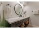 Well-lit bathroom with white countertop, dark wood cabinets, modern fixtures, and neutral decor at 1808 S Sailors Way, Gilbert, AZ 85295
