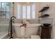 Bright bathroom features a soaking tub with a view and elegant finishes including marble backsplash at 1808 S Sailors Way, Gilbert, AZ 85295