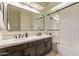Bathroom featuring double sink vanity with quartz countertop and framed shower with white subway tile surround at 1808 S Sailors Way, Gilbert, AZ 85295