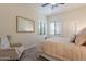 Bedroom with a neutral color palette, an accent chair, a window with blinds, and soft carpet at 1808 S Sailors Way, Gilbert, AZ 85295