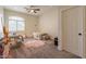 Cozy bedroom with two twin beds, plush rug, and natural light from a large arched window at 1808 S Sailors Way, Gilbert, AZ 85295