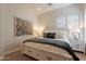 Bright bedroom boasts a decorative rug, neutral walls, and a bed with drawer storage at 1808 S Sailors Way, Gilbert, AZ 85295