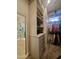 Walk-in closet features custom shelving with access to a shower at 1808 S Sailors Way, Gilbert, AZ 85295