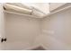 Walk-in closet with upper shelves and white walls is ready for storage at 1808 S Sailors Way, Gilbert, AZ 85295